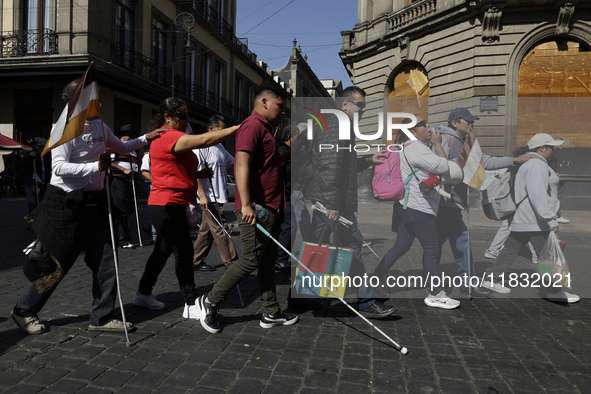 People with disabilities demonstrate on the occasion of the International Day of Persons with Disabilities, marching on Avenida Juarez to th...