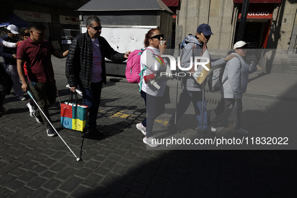 People with disabilities demonstrate on the occasion of the International Day of Persons with Disabilities, marching on Avenida Juarez to th...