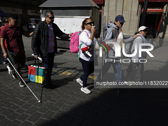 People with disabilities demonstrate on the occasion of the International Day of Persons with Disabilities, marching on Avenida Juarez to th...