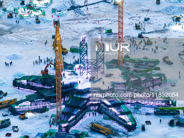 An ice sculpture is under construction at the 26th Ice and Snow World in Harbin, China, on December 3, 2024. 