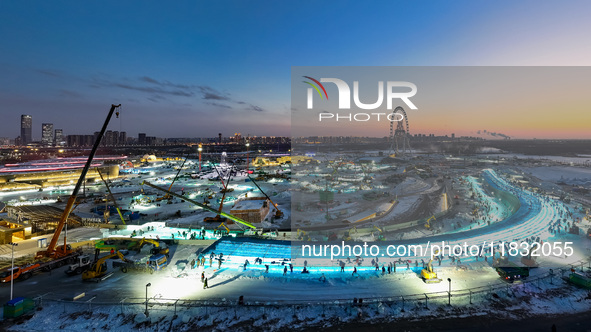 An ice sculpture is under construction at the 26th Ice and Snow World in Harbin, China, on December 3, 2024. 