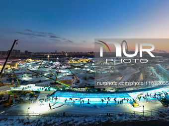 An ice sculpture is under construction at the 26th Ice and Snow World in Harbin, China, on December 3, 2024. (