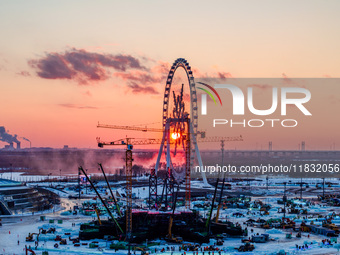 An ice sculpture is under construction at the 26th Ice and Snow World in Harbin, China, on December 3, 2024. (