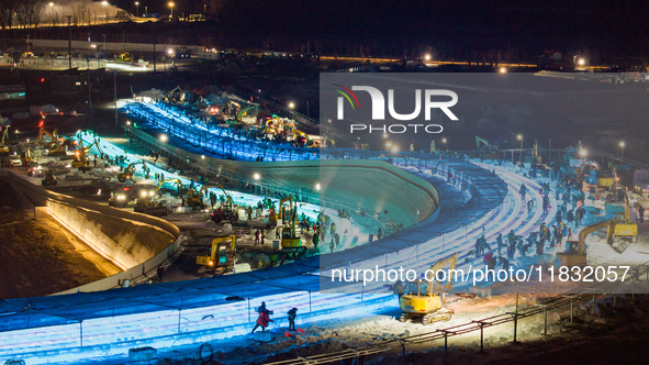 An ice sculpture is under construction at the 26th Ice and Snow World in Harbin, China, on December 3, 2024. 