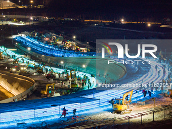 An ice sculpture is under construction at the 26th Ice and Snow World in Harbin, China, on December 3, 2024. (