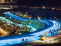 An ice sculpture is under construction at the 26th Ice and Snow World in Harbin, China, on December 3, 2024. (