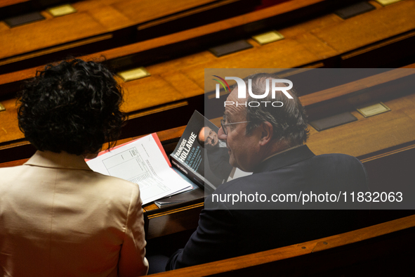 Francois Hollande, former French President and now deputy of the Socialistes et Apparentes group, holds his book at the National Assembly in...