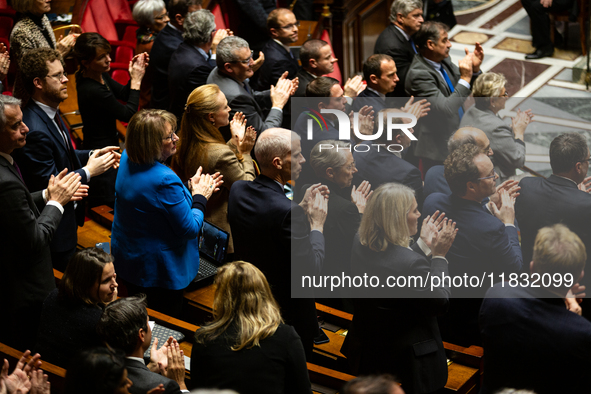 MP deputies of Ensemble pour la Republique applaud the speech of Prime Minister Michel Barnier (not seen in picture) during the questions to...