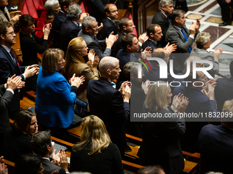 MP deputies of Ensemble pour la Republique applaud the speech of Prime Minister Michel Barnier (not seen in picture) during the questions to...