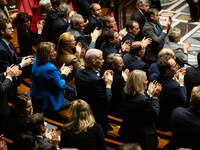 MP deputies of Ensemble pour la Republique applaud the speech of Prime Minister Michel Barnier (not seen in picture) during the questions to...