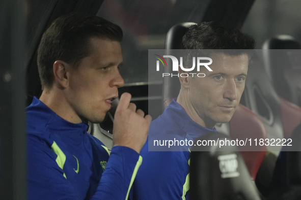 (L) Wojciech Szczesny goalkeeper of Barcelona and Poland and (R) Robert Lewandowski centre-forward of Barcelona and Poland sitting on the be...