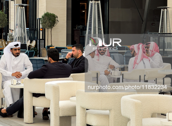 People sit outside a cafe in Downtown in the afternoon in Doha, Qatar, on December 03, 2024. 