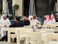 People sit outside a cafe in Downtown in the afternoon in Doha, Qatar, on December 03, 2024. (