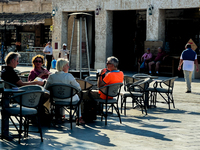 People sit outside a cafe in Downtown in the afternoon in Doha, Qatar, on December 03, 2024. (