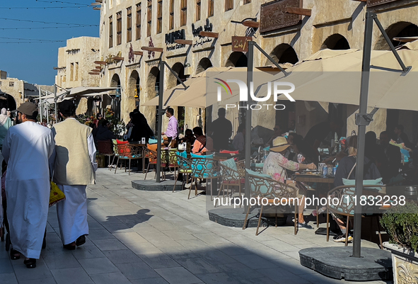 People sit outside a cafe in Downtown in the afternoon in Doha, Qatar, on December 03, 2024. 