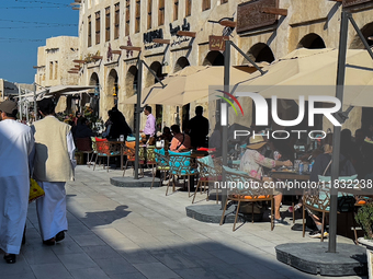 People sit outside a cafe in Downtown in the afternoon in Doha, Qatar, on December 03, 2024. (