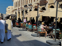 People sit outside a cafe in Downtown in the afternoon in Doha, Qatar, on December 03, 2024. (