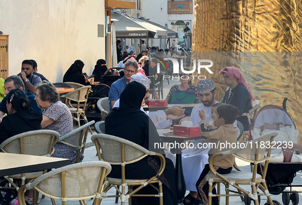 People sit outside a cafe in Downtown in the afternoon in Doha, Qatar, on December 03, 2024. 