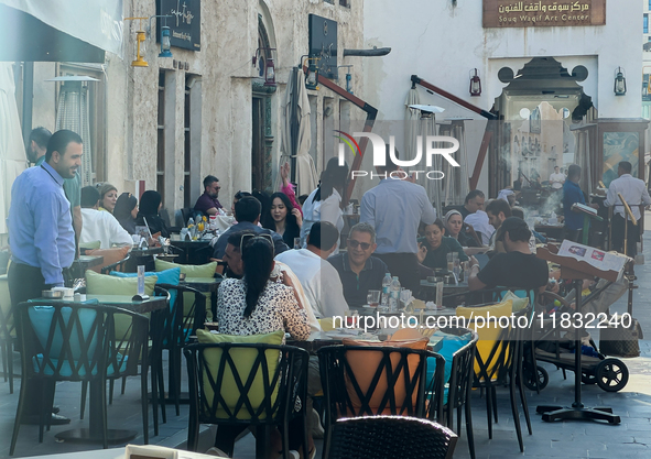 People sit outside a cafe in Downtown in the afternoon in Doha, Qatar, on December 03, 2024. 