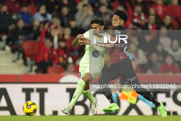 Lamine Yamal right winger of Barcelona and Spain and Johan Mojica left-back of Mallorca and Colombia compete for the ball during the La Liga...