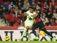 Lamine Yamal right winger of Barcelona and Spain and Johan Mojica left-back of Mallorca and Colombia compete for the ball during the La Liga...