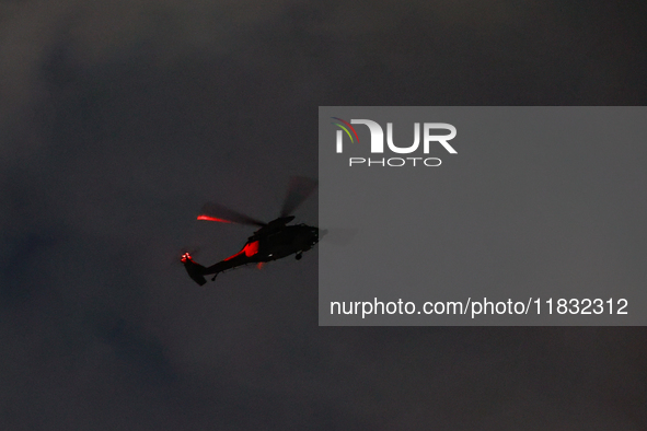 An Apache helicopter under the command of the martial law forces lands at the National Assembly building in Yeouido, in Seoul, South Korea,...