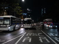 Police buses station outside the main gate of the National Assembly in Seoul, South Korea, on December 4, 2024, forming a human barricade to...