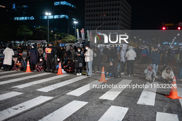 Citizens block the road in front of the National Assembly's main gate in Seoul, South Korea, on December 4, 2024, forming a human barricade...