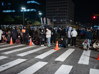 Citizens block the road in front of the National Assembly's main gate in Seoul, South Korea, on December 4, 2024, forming a human barricade...