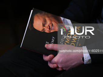 KRAKOW, POLAND - DECEMBER 3:   
A participant holds a copy of Michal Kolanko's book 'Szymon Holownia – Nie dajmy się podzielic' (Szymon Holo...