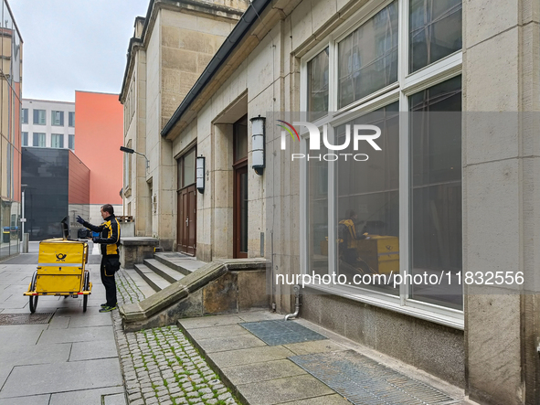 A DHL postman is in Dresden, Saxony, Germany, on March 19, 2022. Due to a new draft law, consumers have to wait longer for a letter in the f...