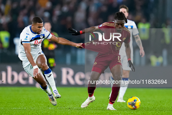 Isak Hien of Atalanta BC and Manu Kone' of AS Roma compete for the ball during the Serie A Enilive match between AS Roma and Atalanta BC at...