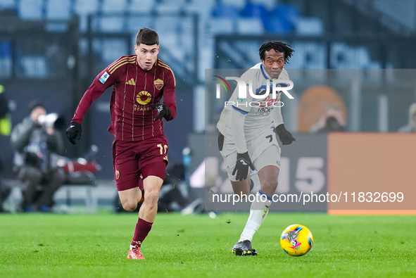 Matias Soule' of AS Roma and Juan Cuadrado of Atalanta BC compete for the ball during the Serie A Enilive match between AS Roma and Atalanta...