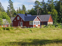 A traditional red-painted house is seen in Markaryd, Sweden, on August 8, 2024. (