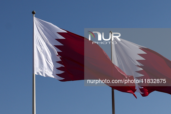 Flags of Qatar are seen near the National Museum of Qatar in Doha, Qatar on December 3, 2024. 