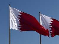 Flags of Qatar are seen near the National Museum of Qatar in Doha, Qatar on December 3, 2024. (