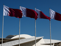 Flags of Qatar are seen near the National Museum of Qatar in Doha, Qatar on December 3, 2024. (