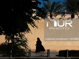 A woman wearing hijab walks in Doha, Qatar on December 3, 2024. (