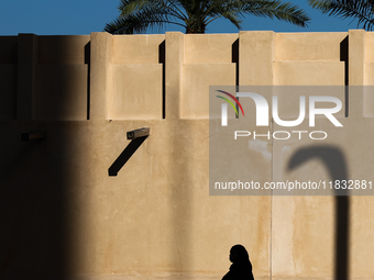 A woman wearing hijab walks in Doha, Qatar on December 3, 2024. (