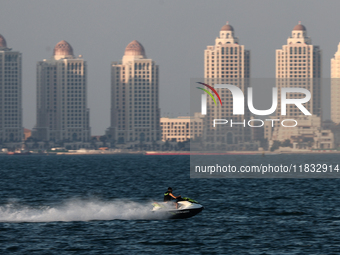 A person rides a jet ski at Doha Bay in Doha, Qatar on December 3, 2024. (