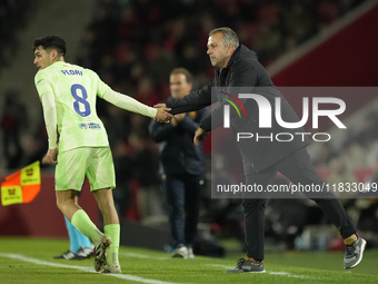 Pedri central midfield of Barcelona and Spain and Hansi Flick head coach of Barcelona during the La Liga match between RCD Mallorca and FC B...