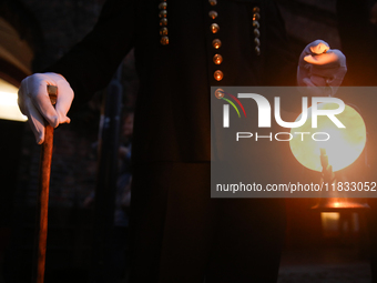 A miner with a lamp participates in the traditional waking up of residents during Barborka in Nikiszowiec, Poland, on December 4, 2024. Barb...