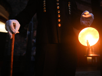 A miner with a lamp participates in the traditional waking up of residents during Barborka in Nikiszowiec, Poland, on December 4, 2024. Barb...