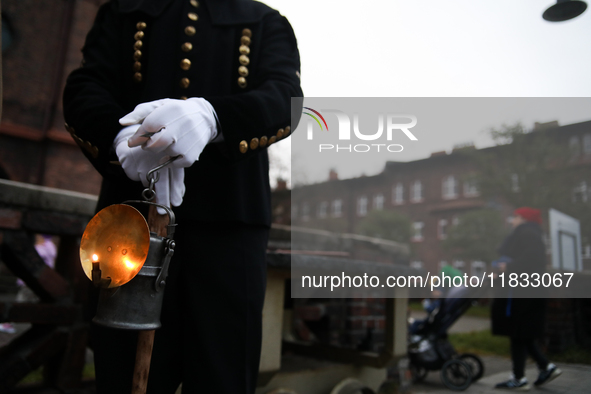 A miner with a lamp participates in the traditional waking up of residents during Barborka in Nikiszowiec, Poland, on December 4, 2024. Barb...