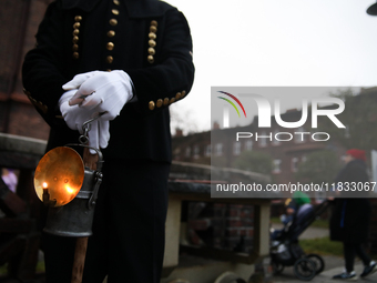 A miner with a lamp participates in the traditional waking up of residents during Barborka in Nikiszowiec, Poland, on December 4, 2024. Barb...