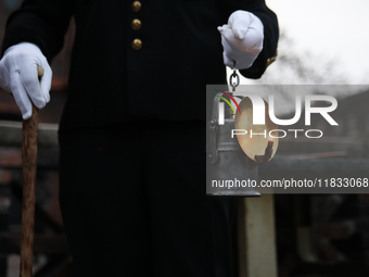 A miner with a lamp participates in the traditional waking up of residents during Barborka in Nikiszowiec, Poland, on December 4, 2024. Barb...