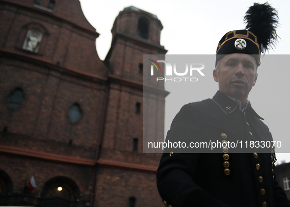 A miner participates in the traditional waking up of residents during Barborka in Nikiszowiec, Poland, on December 4, 2024. Barborka is a tr...