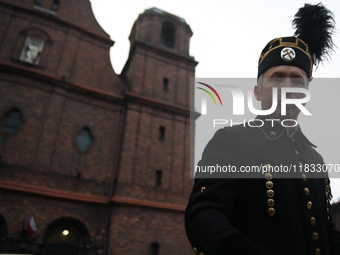 A miner participates in the traditional waking up of residents during Barborka in Nikiszowiec, Poland, on December 4, 2024. Barborka is a tr...