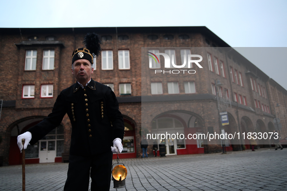 A miner with a lamp participates in the traditional waking up of residents during Barborka in Nikiszowiec, Poland, on December 4, 2024. Barb...