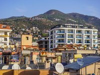 A general view of the dense city development with visible roofs full of solar installations for heating water is seen in Alanya, Antalya, Tu...